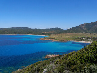 Obraz premium Panoramic view of Capo di Feno bay with turquoise water and mountains in Corsica France