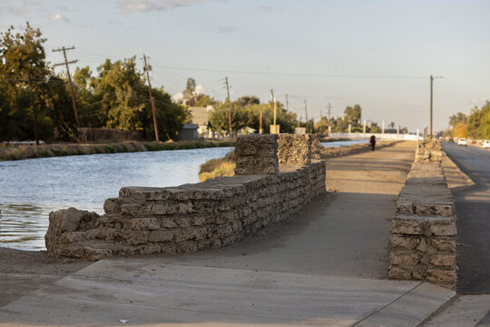 Sunset view of a bridge over an irrigation canal in downtown Dos Palos, Caliofrnia, USA.