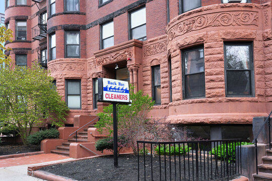 Old brownstone apartment building with sign for cleaners, Back Bay area of Boston, Massachusetts