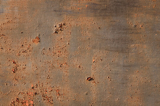 Rusty metal surface texture, orange corrosion on brown iron plate background