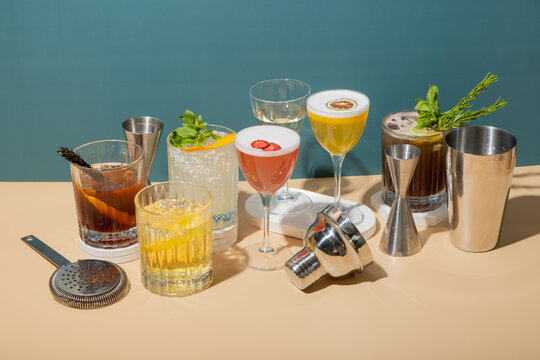 Enjoy time with different drinks and cocktails on a light surface in a relaxed setting near the sea during daylight