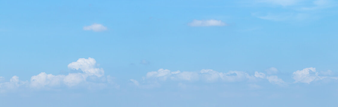 Panoramic vibrant blue sky background with soft white clouds and bright daylight for natural backdrop and clean outdoor design