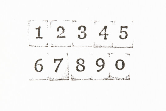 Numbers from 1 to 0 stamped with black ink on clean white background. Minimalist style.