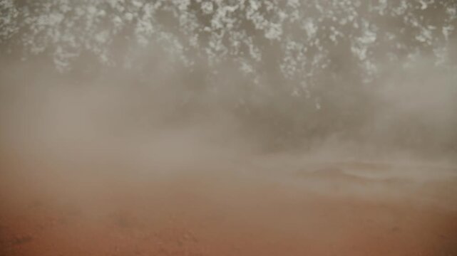 Solidified lava in crater and smoke billowing from cracks as result of active volcanic activity. Close-up. Slow motion. Concept of power of wild nature