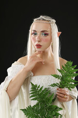 Naklejka premium Beautiful elf girl with floral decor on black background