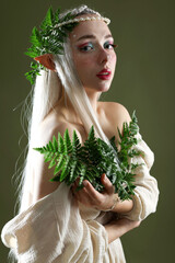 Naklejka premium Beautiful elf girl with floral decor on dark olive background