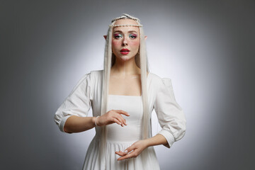 Naklejka premium Beautiful elf girl on grey gradient background