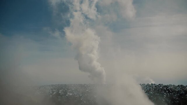 Close-up of solidified lava and steam clouds rising from cracks in volcano's crater. Volcanic activity concept