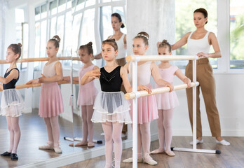Lesson for little ballerinas - girls learn to dance ballet in a choreographic class © JackF