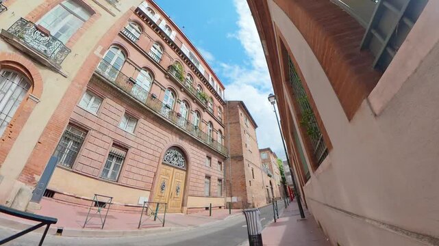 historic red brick townhouse ornate wooden door narrow European street upward view blue sky