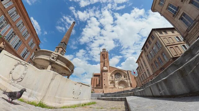 timelapse Toulouse saint etienne historic cathedral tower clock rose window plaza fountain pigeon low angle blue sky