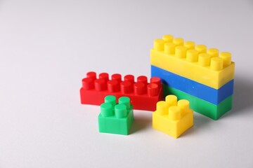 Fototapeta premium Construction toy. Building blocks on light background, closeup. Space for text