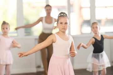 Ballet lesson for children - choreographer teaches girls ballet steps © JackF