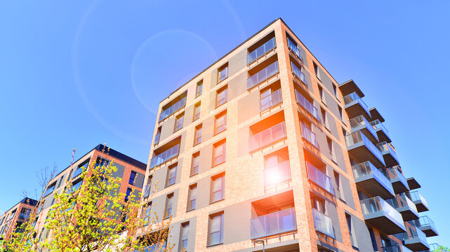 European residential architecture harmonizing with nature. Eco-friendly living in city with greens. Eco apartment building saving energy and fresh air concept. 