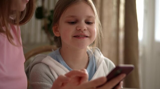 White girl examining phone with mother, cozy home lighting, mother gently guiding fingertip across screen, daughter smiling with curious expression, intimate .