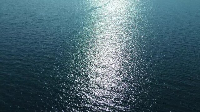 Aerial Transition from Sea to Land with Sun Reflection in Izmir Turkiye