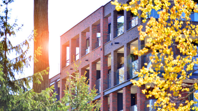 European residential architecture harmonizing with nature. Eco-friendly living in city with greens. Eco apartment building saving energy and fresh air concept. 