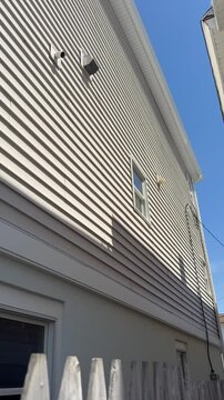 Vertical close up view of the siding of a new house 