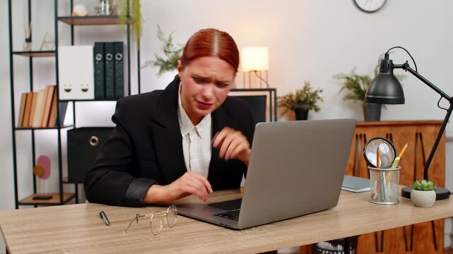 Young businesswoman at home office sees hazy laptop text wears glasses and watches clarity return. Freelancer girl at table delights in very clear screen as eyesight improves enabling productive work