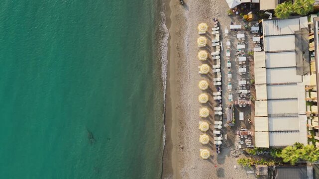 Aerial Video Beach Club Area with Tables, Chairs, and Sun Umbrellas