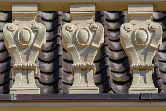 View of the ornate cream-colored balusters of Castle Groeneveld with dark roof tiles in the background in Baarn, Utrecht, Netherlands.