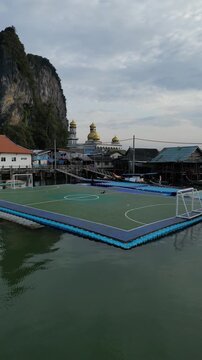 Drone Flying Away from Floating Soccer Field in Ko Panyi Village, Phang Nga, Thailand