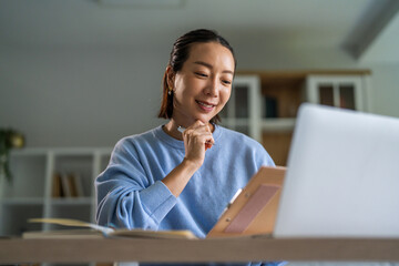 Young woman smiling doing video call work from home