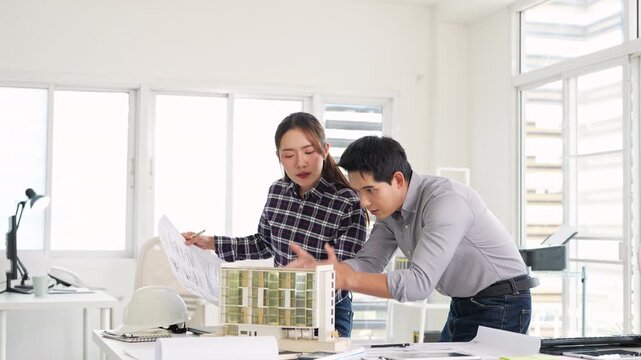 Architecture, design engineers, and architects converse in the office, demonstrating collaboration between civil engineering architect designer team in the workplace, brainstorming for a project.