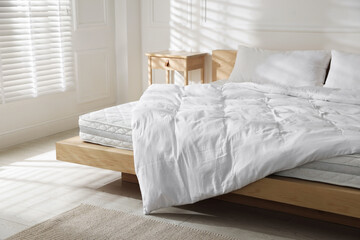 Fototapeta premium Orthopedic mattress, pillows and duvet on bed at home