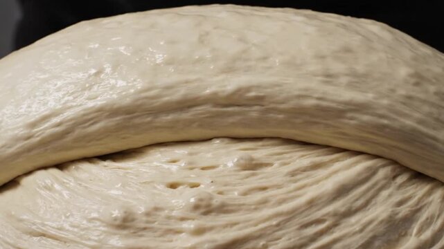 Close-up of Baker Stretching and Folding Sourdough Bread Dough Showing Gluten Structure