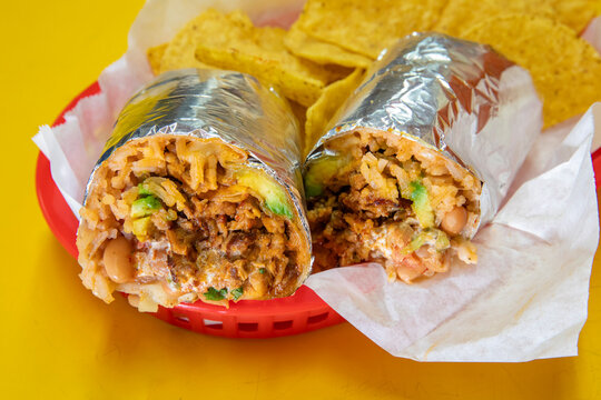 Beef burrito with salsa in red basket