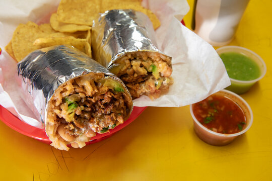 Beef burrito with salsa in red basket