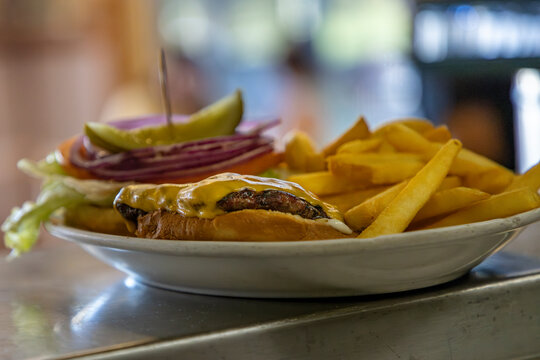 Open face hamburger with fries in restaurant