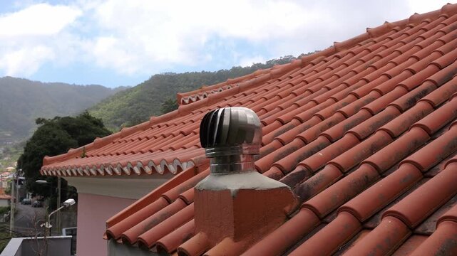 Decorative chimney vent on traditional red tile roof Madeira Portugal