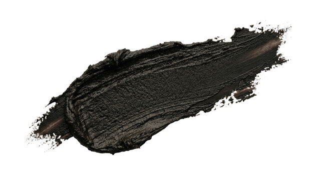 Close up of black cosmetic clay smear on isolated background, beauty treatment and skin care concept