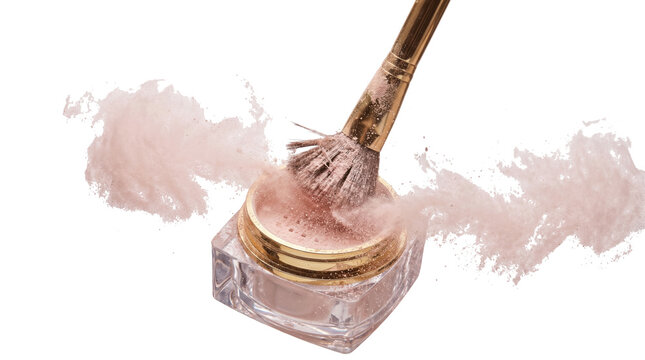 Close up of makeup brush touching face powder in container with powder flying around on isolated background