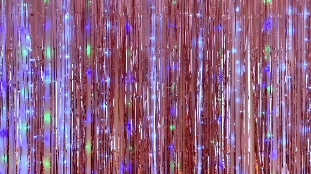 Shiny tinsel curtain background with colorful glitter and sparkling lights, festive party decoration