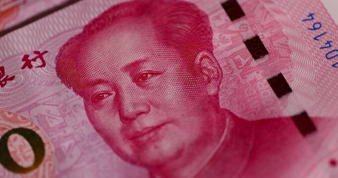 Chinese yuan with a face value of 100 folded together, a large amount of Chinese cash invested together, close up