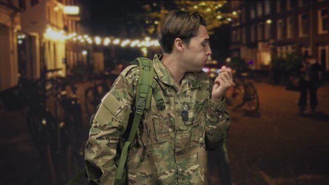 Soldier man in camouflage pinching nose and holding out hand on an urban street with string lights at night, backpack and dog tags visible; disgust avoidance.