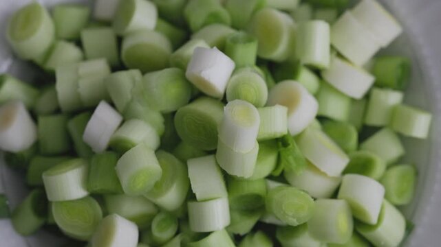 Close-up of fresh sliced leeks on a wooden cutting board