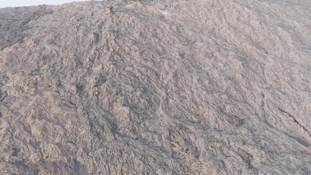 Aerial view of the intricate textures and patterns of solidified lava fields at the Erta Ale Volcano crater in the Danakil Depression, Afar, Ethiopia.
