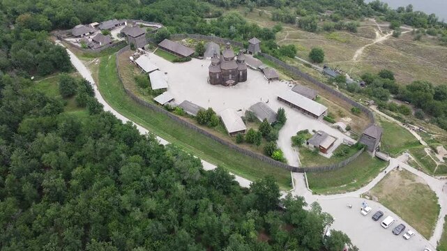Horizontal drone view of Khortytsia Island and an ancient Cossack settlement in Ukraine, showcasing heritage, nature, and history