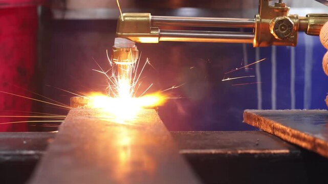 Industrial Oxy-Fuel Cutting Torch Processing Steel Plate with Sparks
