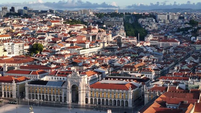 Aerial view of Praca do Comercio with the Rua Augusta Arch and red-tiled rooftops under a clear sky in Lisbon, Lisbon, Portugal.