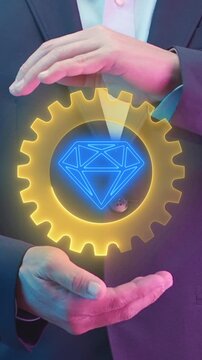 Growth value, increasing value added to business product and service. Business and finance growth concept. Businessman showing glowing neon line of daimond inside cogwheel icon on virtual screen.