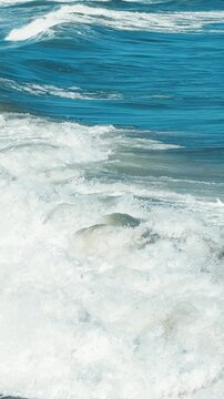 Peaceful seaside scene with slow motion ocean waves, filmed vertically for modern mobile-first content.