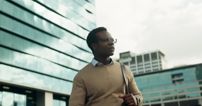Businessman, walk and commute in city with thinking, bag or property listing for real estate career. Low angle, black person and realtor outdoor downtown with glasses, reflection or urban development