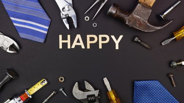 Happy Fathers Day wood letter greeting with tools and ties on a black background. Stop motion video.