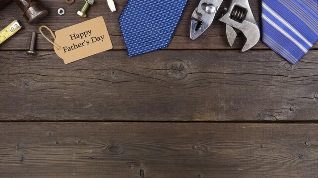 Happy Fathers Day gift tag with top border of tools and ties on a dark wood background. Stop motion loopable video.