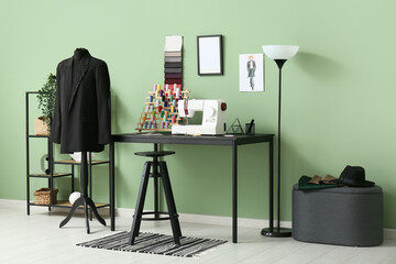 Naklejka premium Interior of atelier with tailor's workplace, shelf unit and mannequin